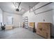 Tidy garage featuring storage shelving and natural light, offering space for parking and organization at 4825 S Ammons St # 102, Littleton, CO 80123