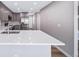 Bright kitchen featuring sleek countertops, stainless appliances, and eat-in bar with modern finishes at 4825 S Ammons St # 102, Littleton, CO 80123