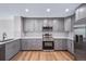 Updated kitchen with gray cabinets, stainless steel appliances, and modern backsplash at 4825 S Ammons St # 102, Littleton, CO 80123