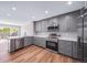 Renovated kitchen showcases stainless steel appliances, gray cabinets and easy access to backyard patio at 4825 S Ammons St # 102, Littleton, CO 80123