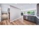 Updated kitchen featuring modern appliances and breakfast bar that flows into the dining and living room at 4825 S Ammons St # 102, Littleton, CO 80123