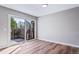 Living room featuring wood floors, a sliding glass door to the backyard, gray walls and natural light at 4825 S Ammons St # 102, Littleton, CO 80123
