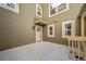 Side of home view with deck, natural light, tan siding, and white trim at 4825 S Ammons St # 102, Littleton, CO 80123