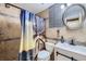 Bathroom with decorative vanity, attractive mirror, and palm tree shower curtain providing a beach vibe at 11964 W 71St Pl, Arvada, CO 80004