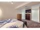 Finished basement bedroom features a mounted TV, closet, and a large bed at 11964 W 71St Pl, Arvada, CO 80004