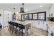 Bright, modern kitchen with large island, stainless steel appliances, and backyard view at 11964 W 71St Pl, Arvada, CO 80004