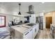 Contemporary kitchen with marble island, stainless steel appliances, and open layout at 11964 W 71St Pl, Arvada, CO 80004