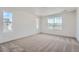 Bright bedroom featuring neutral carpet, white walls, recessed lighting, and multiple windows for ample natural light at 2080 S Haleyville Way, Aurora, CO 80018