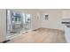 Bright Living room boasting hardwood flooring, a glass door leading to a balcony, and abundant light at 2080 S Haleyville Way, Aurora, CO 80018