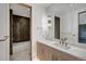 Beautiful bathroom featuring a marble countertop vanity and tiled shower and bathtub area, creating a luxurious retreat at 294 Gold Run Rd, Breckenridge, CO 80424