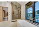 Luxurious bathroom showcasing a standalone tub, walk-in shower, and a large window with a serene outdoor view at 294 Gold Run Rd, Breckenridge, CO 80424