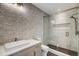 Bathroom with textured tile wall, glass shower, and modern vanity at 294 Gold Run Rd, Breckenridge, CO 80424