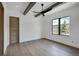 Bright bedroom with wood flooring, exposed beams, natural light, and beautiful outdoor views at 294 Gold Run Rd, Breckenridge, CO 80424