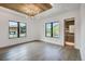 Stylish bedroom with wood ceiling and modern light fixture with views of the outside landscape at 294 Gold Run Rd, Breckenridge, CO 80424
