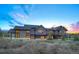 Majestic home set against a colorful sunset backdrop, showcasing the property's size and curb appeal at 294 Gold Run Rd, Breckenridge, CO 80424