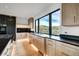 Modern kitchen with light wood cabinets, black countertops, stainless steel appliances, and scenic views at 294 Gold Run Rd, Breckenridge, CO 80424