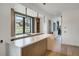 Modern kitchen with a large island, bright countertops, pendant lighting, and backyard views at 294 Gold Run Rd, Breckenridge, CO 80424