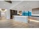 Open-concept kitchen with a large island, modern appliances, wooden cabinetry, and scenic window views at 294 Gold Run Rd, Breckenridge, CO 80424