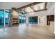 Spacious living room boasting high ceilings, stone fireplace, wood beams, and expansive windows with mountain views at 294 Gold Run Rd, Breckenridge, CO 80424