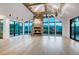 Bright living room with a stone fireplace, high ceilings, and large windows offering panoramic mountain views at 294 Gold Run Rd, Breckenridge, CO 80424