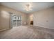 Clean bedroom featuring plush carpet, large windows, and access to a private balcony at 74 Whitehaven Cir, Highlands Ranch, CO 80129