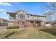 Inviting two-story home featuring gray siding, brick accents, a covered porch, and well-maintained lawn at 74 Whitehaven Cir, Highlands Ranch, CO 80129