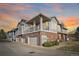 Multi-level townhome showcasing a mix of brick and siding, a private balcony, and attached garage bays at 74 Whitehaven Cir, Highlands Ranch, CO 80129