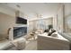 Bright and airy living room features fireplace, neutral tones, and ample natural light at 74 Whitehaven Cir, Highlands Ranch, CO 80129