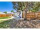 View of a backyard featuring a concrete patio, mature tree, and fenced yard space at 2625 S Linley Ct, Denver, CO 80219