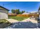 Backyard with concrete patio and a fenced-in yard space for outdoor activities at 2625 S Linley Ct, Denver, CO 80219