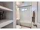 Modern bathroom with a tiled shower, built-in shelving, and a sleek, minimalist design at 2625 S Linley Ct, Denver, CO 80219