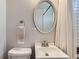 Clean bathroom with a stylish mirror, white fixtures, and tiled shower area for a modern feel at 2625 S Linley Ct, Denver, CO 80219