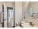 Neutral bathroom featuring a vanity, toilet, and stylish fixtures with a view into the hallway at 2625 S Linley Ct, Denver, CO 80219