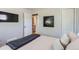 Cozy bedroom with a mounted TV, art, comfortable bed, and access to a stylish bathroom at 2625 S Linley Ct, Denver, CO 80219