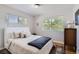Inviting bedroom with natural light, plush bedding, and a serene view of the outdoors at 2625 S Linley Ct, Denver, CO 80219
