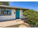 A close-up of the front of the home highlighting a striking blue door and manicured landscaping at 2625 S Linley Ct, Denver, CO 80219