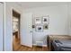 Hallway featuring hardwood floors, various pictures on the wall, and access to other parts of the home at 2625 S Linley Ct, Denver, CO 80219