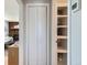Hallway with closet featuring storage shelves and adjacent view into the living room at 2625 S Linley Ct, Denver, CO 80219