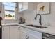 Bright kitchen sink area with white cabinets, marbled countertops, modern faucet, and stylish decor at 2625 S Linley Ct, Denver, CO 80219