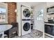 Efficient laundry area featuring a stackable washer and dryer, adjacent shelving, and a convenient exterior door at 2625 S Linley Ct, Denver, CO 80219