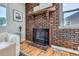 Living room highlighting a brick fireplace and hardwood flooring at 2625 S Linley Ct, Denver, CO 80219