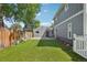 Backyard features a well-manicured lawn, a new wooden fence, a detached garage and beautiful landscaping at 4603 W 33Rd Ave, Denver, CO 80212
