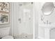 Clean, modern bathroom with glass-enclosed shower and pedestal sink at 4603 W 33Rd Ave, Denver, CO 80212
