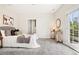 Bright bedroom with a walk-in closet, a sliding door to the outside balcony, and a cozy rug at 4603 W 33Rd Ave, Denver, CO 80212