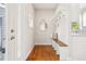 Inviting entryway with wooden bench, coat hooks, and bright natural light at 4603 W 33Rd Ave, Denver, CO 80212