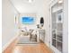 Neutral entryway with a tv, hardwood floors, a desk, and a door leading to the outside at 4603 W 33Rd Ave, Denver, CO 80212