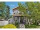 Beautiful two-story home with gray siding, a charming balcony, professional landscaping, and manicured lawn at 4603 W 33Rd Ave, Denver, CO 80212