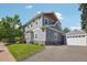 Charming gray home with a well-maintained lawn and a detached garage, showcasing curb appeal and functionality at 4603 W 33Rd Ave, Denver, CO 80212