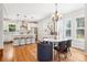 Bright, open kitchen with stainless steel appliances, modern pendant lights, and wood floors at 4603 W 33Rd Ave, Denver, CO 80212