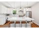 Bright kitchen featuring an island, stainless appliances, modern pendant lights, and wood floors at 4603 W 33Rd Ave, Denver, CO 80212